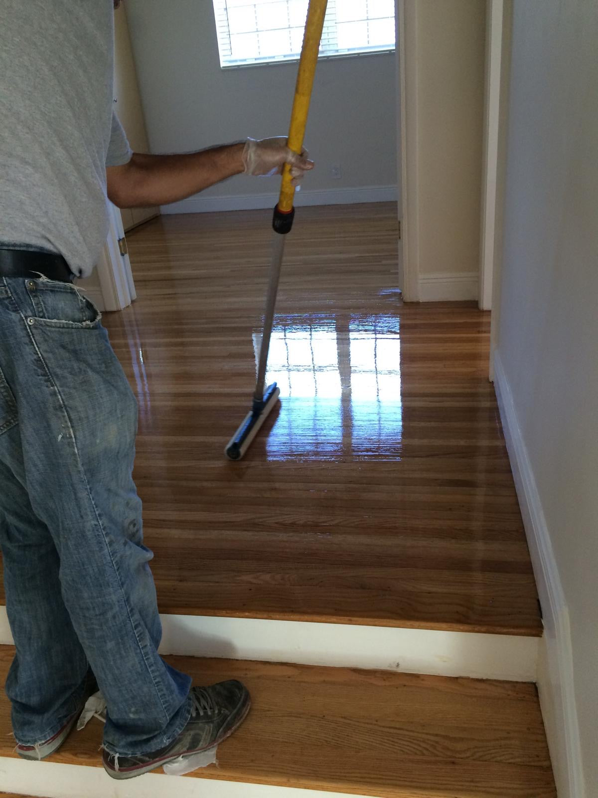 Applying finish to hardwood floor during refinish